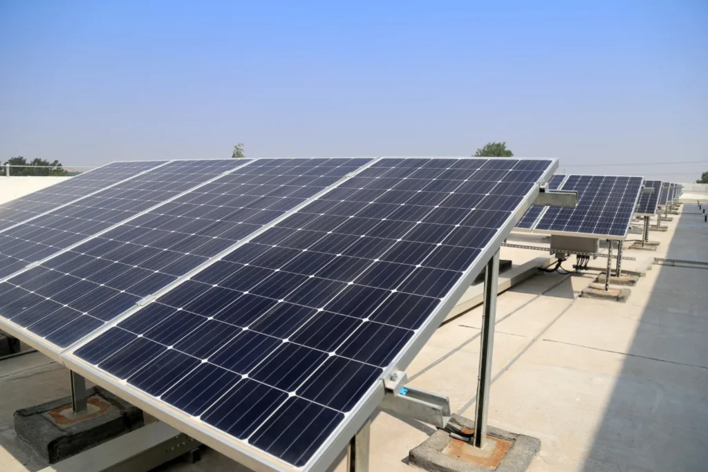 Rooftop solar panel array under clear blue sky